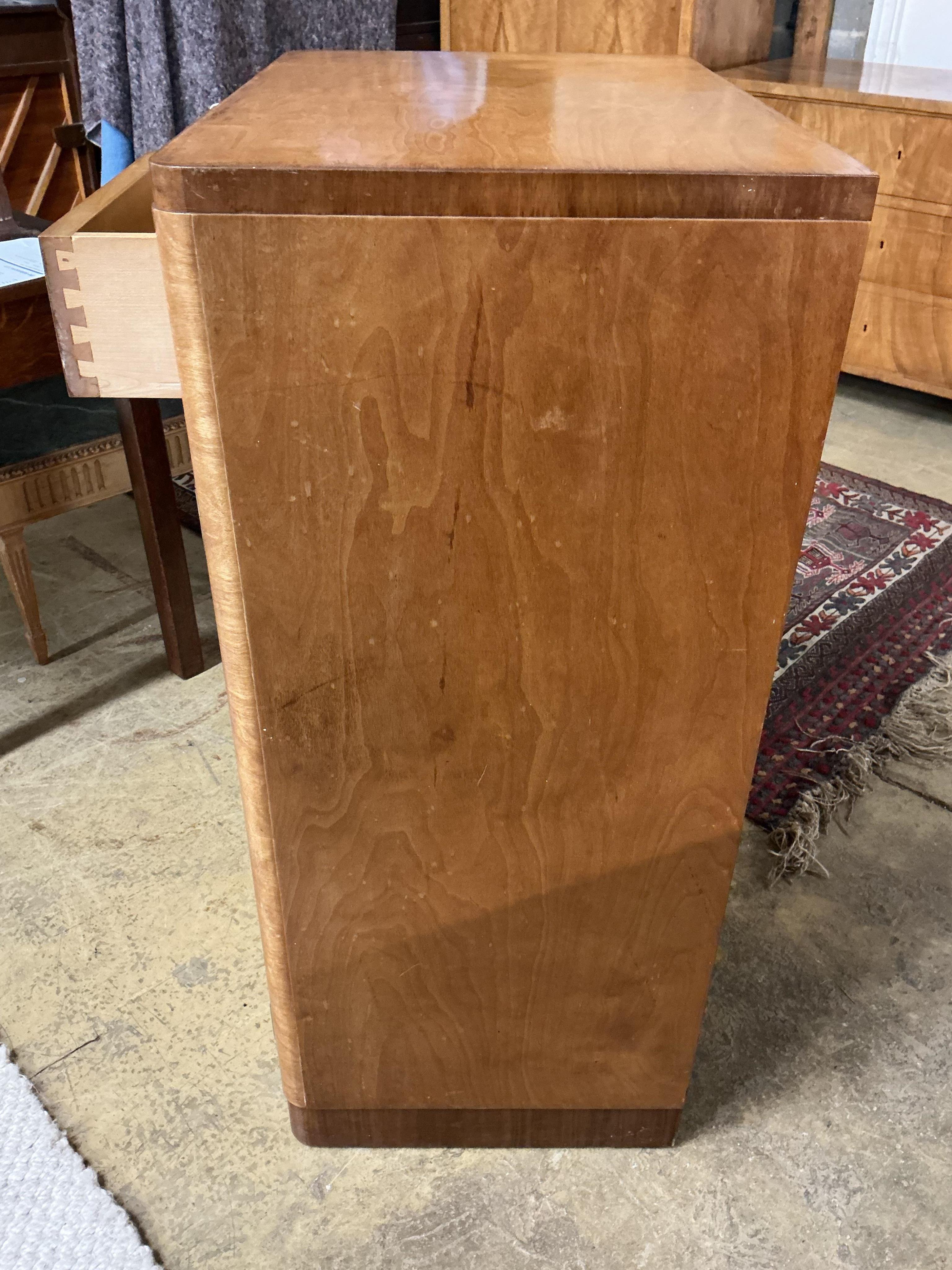 An early 20th century maple two drawer press cupboard, width 68cm, depth 45cm, height 107cm
